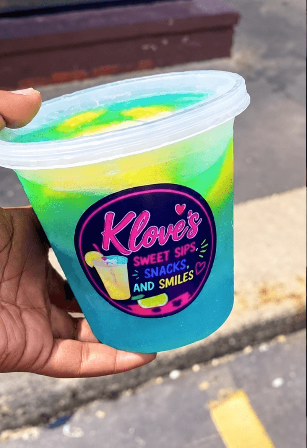 A real KLove's Blue Lagoon lemonade bucket with blue, green, and yellow color