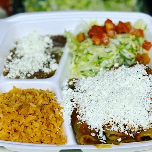 La Tapatia Mexican meal with enchiladas, rice, beans, lettuce, tomato, and cheese