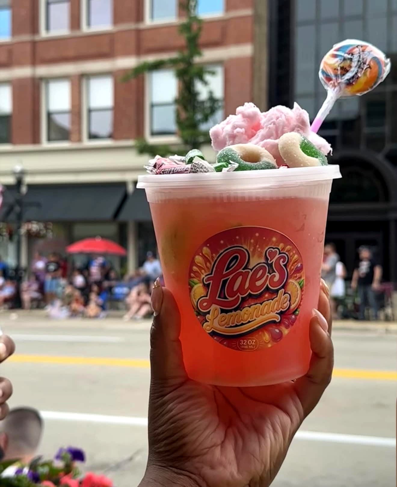 Vendor-supplied photo of a Lae's Lemonade candy-topped drink at a community festival